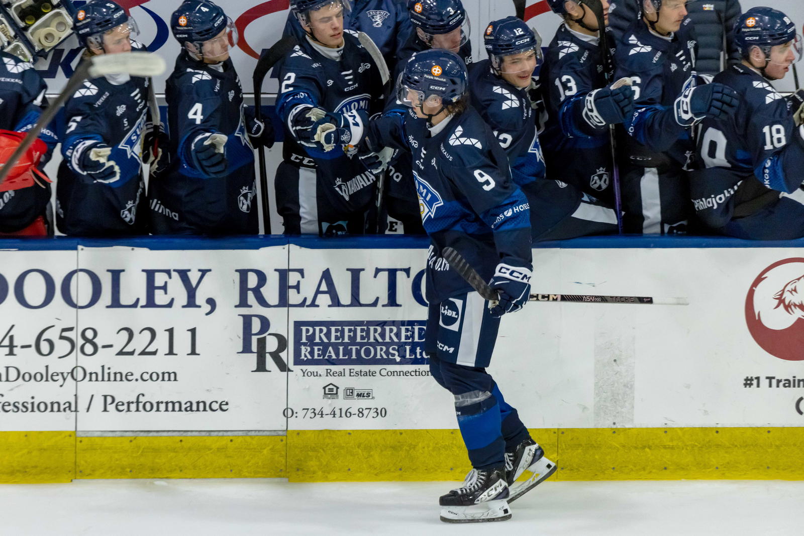 Aug 2, 2024; Plymouth, MI, USA; Finland's defenseman Emil Pieniniemi (9) celebrates a power play goal against Canada with teammates on the bench during the second period of the 2024 World Junior Summer Showcase at USA Hockey Arena. Mandatory Credit: David Reginek-Imagn Images