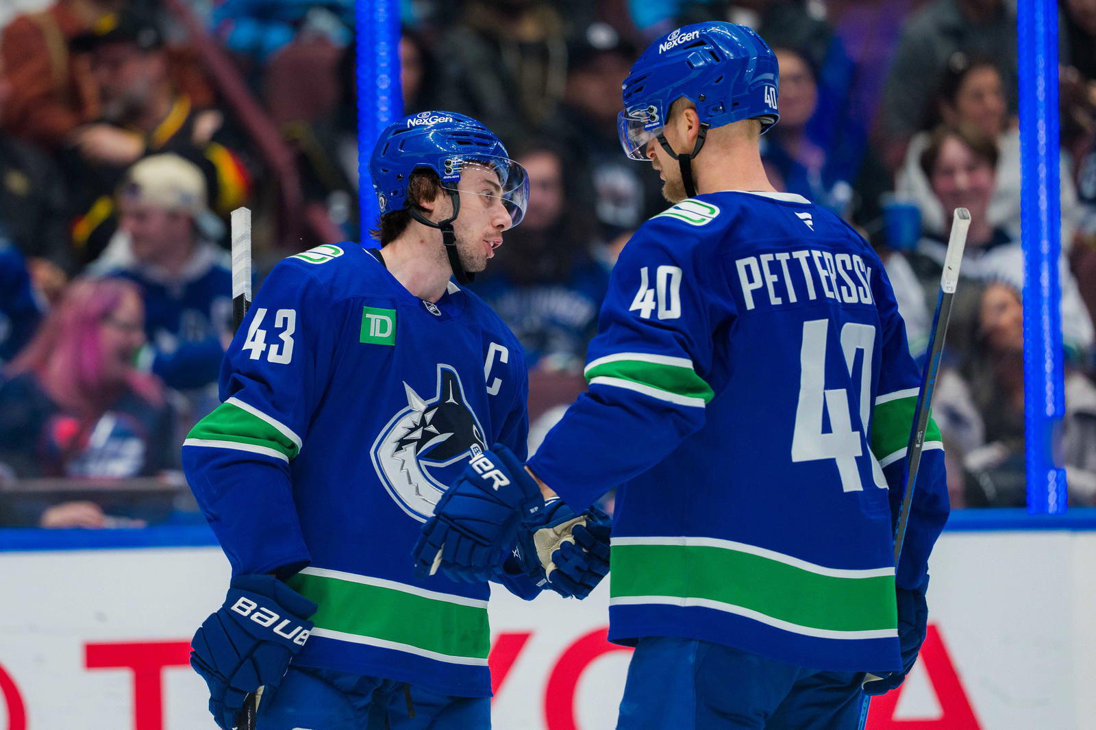 Mar 18, 2025; Vancouver, British Columbia, CAN; Vancouver Canucks defenseman Quinn Hughes (43) talks with forward Elias Pettersson (40) during a stop in play against the Winnipeg Jets in the third period at Rogers Arena. Mandatory Credit: Bob Frid-Imagn Images