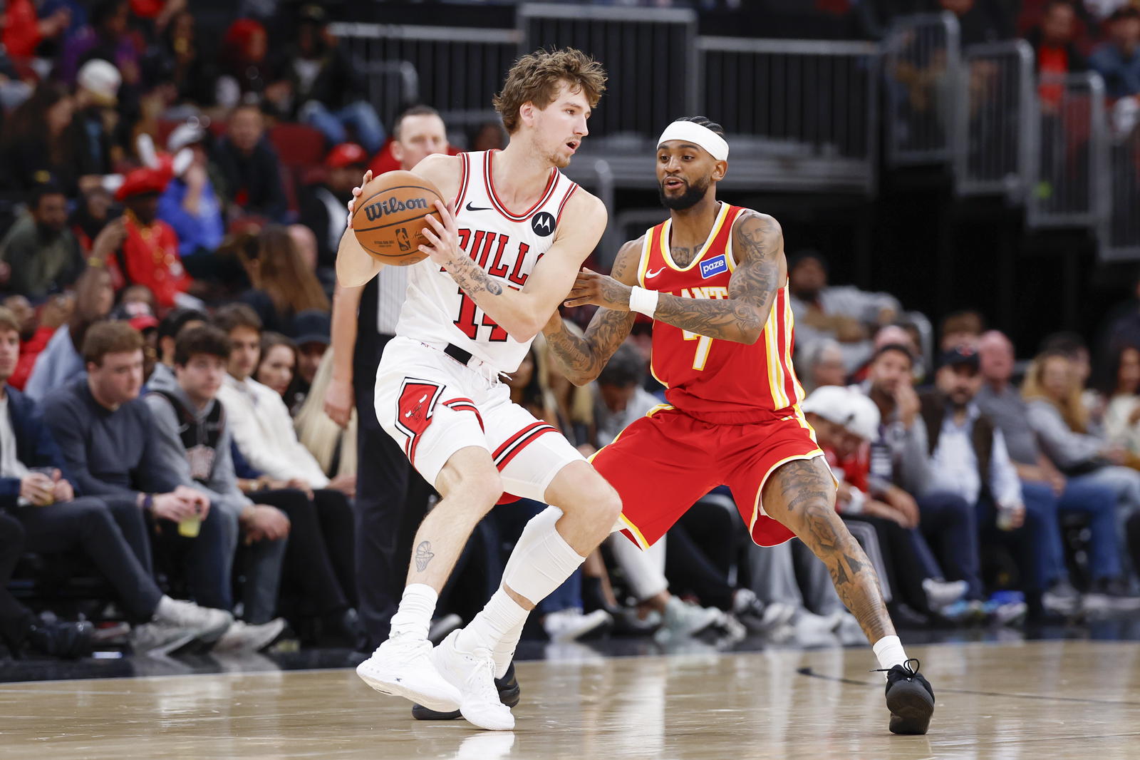 Oct 27, 2025; Chicago, Illinois, USA; Atlanta Hawks guard Nickeil Alexander-Walker (7) defends against Chicago Bulls forward Matas Buzelis (14) during the second half at United Center. Mandatory Credit: Kamil Krzaczynski-Imagn Images