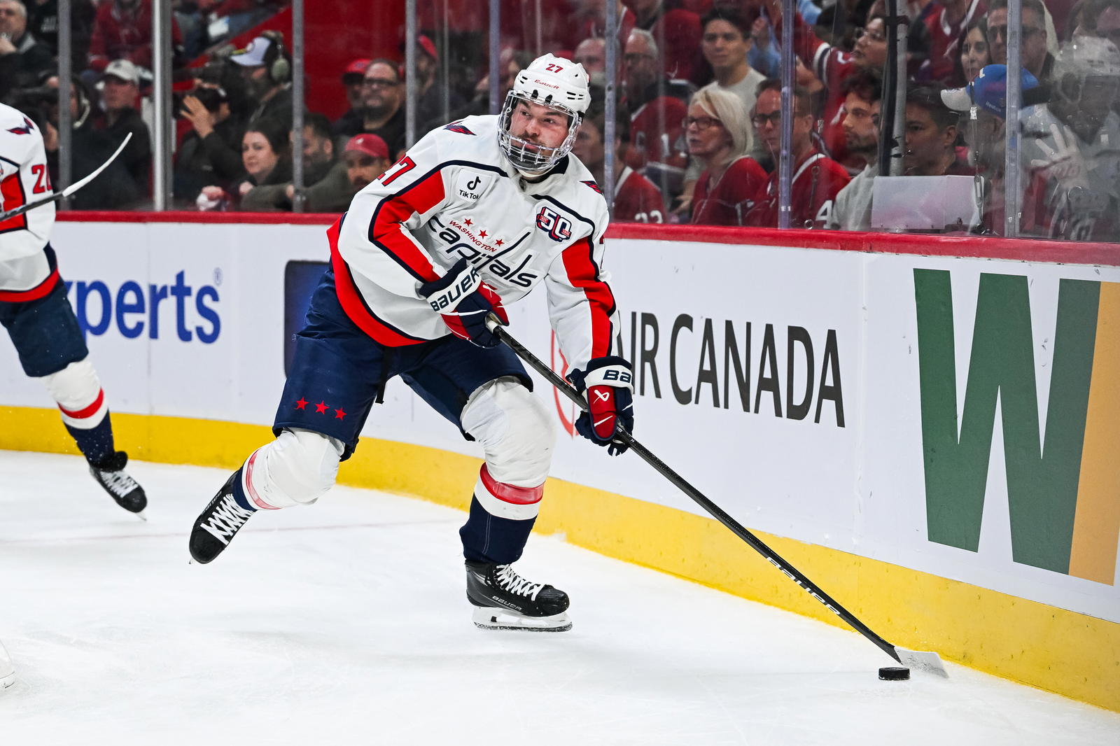Apr 27, 2025; Montreal, Quebec, CAN; Washington Capitals defenseman Alex Alexeyev (27) plays the puck near the boards against the Montreal Canadiens during the first period in game four of the first round of the 2025 Stanley Cup Playoffs at Bell Centre. Mandatory Credit: David Kirouac-Imagn Images
