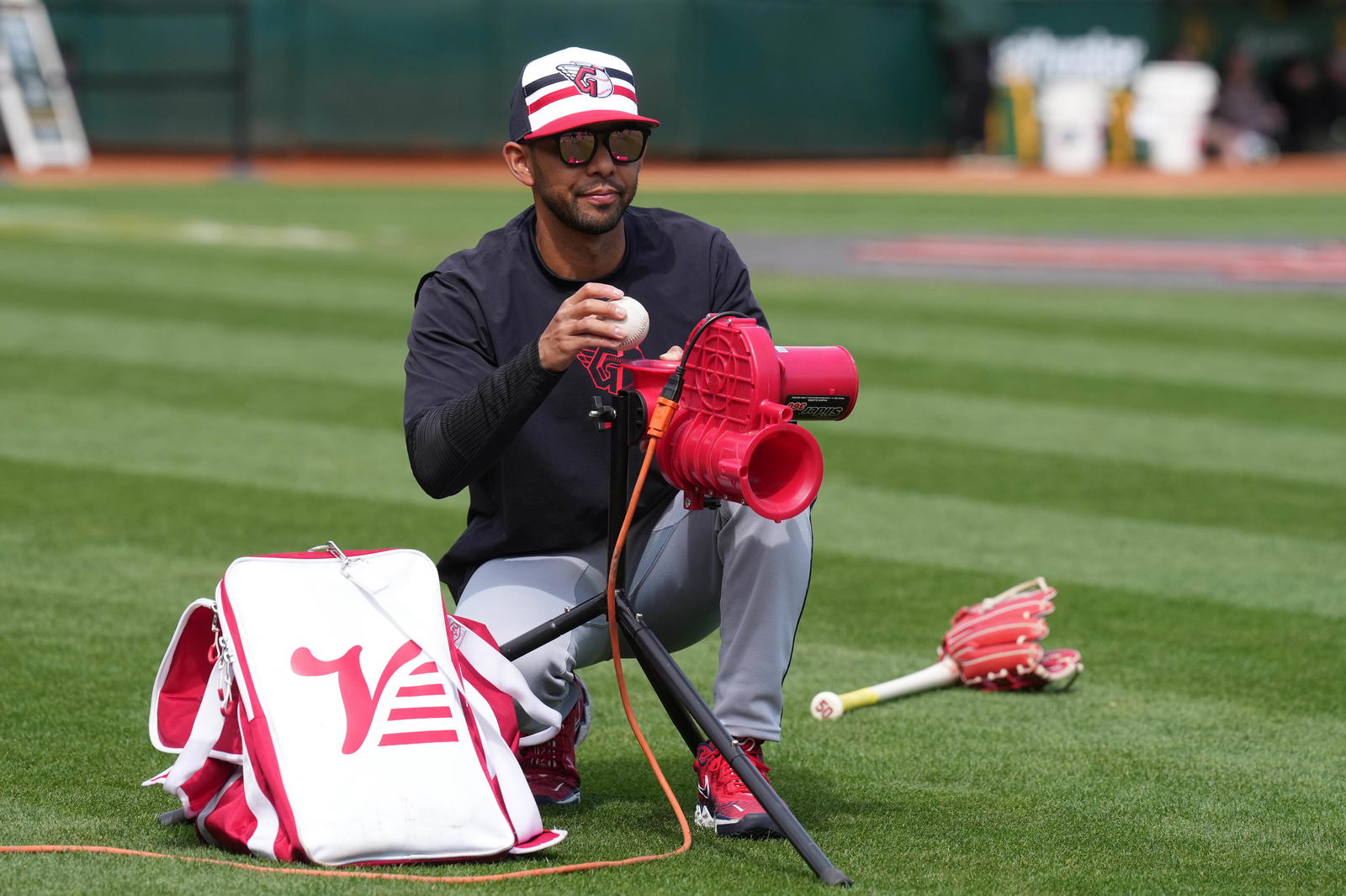 Mar 30, 2024; Oakland, California, USA; Cleveland Guardians major league field coordinator Kai Correa works on the field before the game against the Oakland Athletics at Oakland-Alameda County Coliseum. Mandatory Credit: Darren Yamashita-Imagn Images