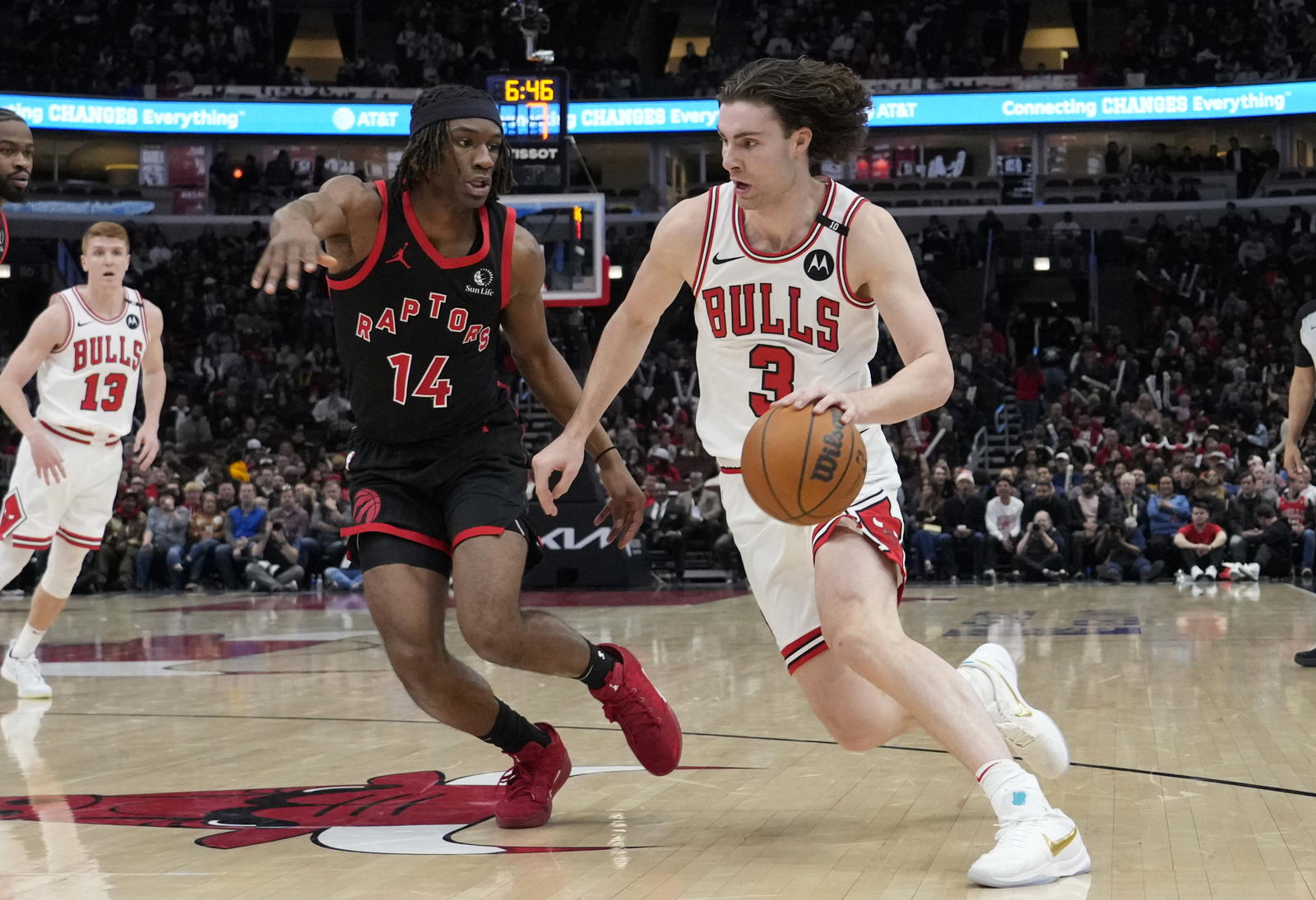 Apr 1, 2025; Chicago, Illinois, USA; Toronto Raptors guard Ja'Kobe Walter (14) defends Chicago Bulls guard Josh Giddey (3) during the second half at United Center. Mandatory Credit: David Banks-Imagn Images