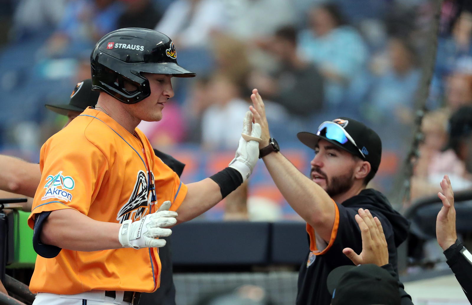 Akron RubberDucks’ Joe Lampe is welcomed back to the dugout after his solo homer during the second inning of a Minor League Baseball game at Canal Park, Aug. 21, 2025, in Akron, Ohio.