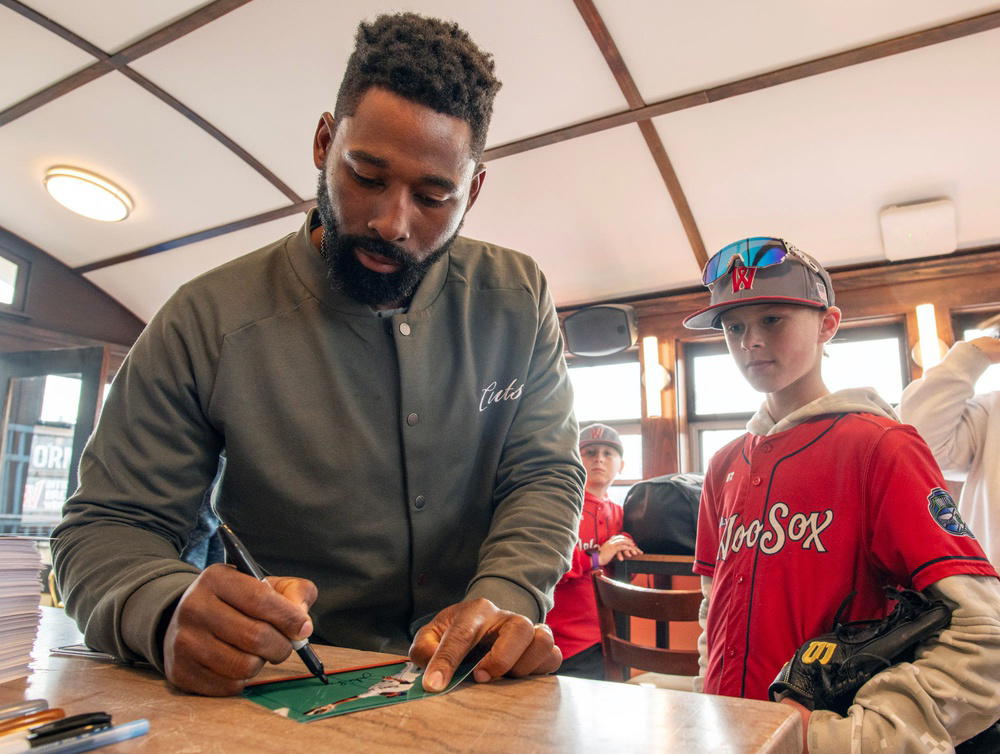 Former Boston Red Sox player Jackie Bradley Jr. signs an autograph for Junior WooSox player Colton Amato of Shrewsbury on opening day at Polar Park Friday. (Rick Cinclair/Telegram &amp; Gazette/USA TODAY NETWORK/Imagn Images)