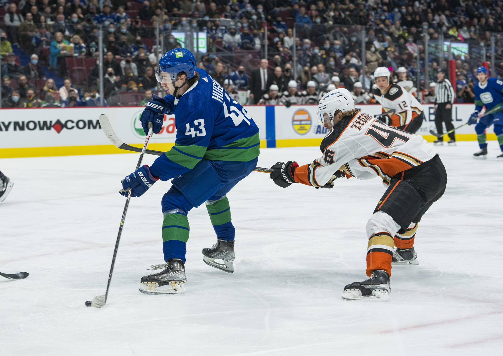 Nov 9, 2021; Vancouver, British Columbia, CAN; Anaheim Ducks forward Trevor Zegras (46) checks Vancouver Canucks defenseman Quinn Hughes (43) in the first period at Rogers Arena. Mandatory Credit: Bob Frid-Imagn Images