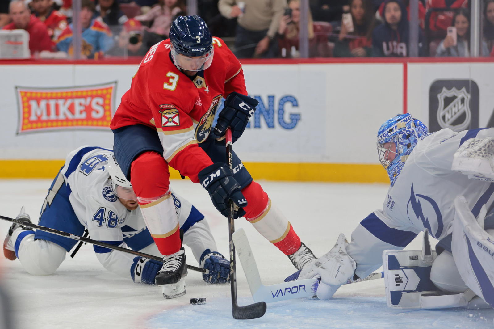 Mar 3, 2025; Sunrise, Florida, USA; Florida Panthers defenseman Seth Jones (3) moves the puck past Tampa Bay Lightning defenseman Nick Perbix (48) during the second period at Amerant Bank Arena. (Sam Navarro-Imagn Images)