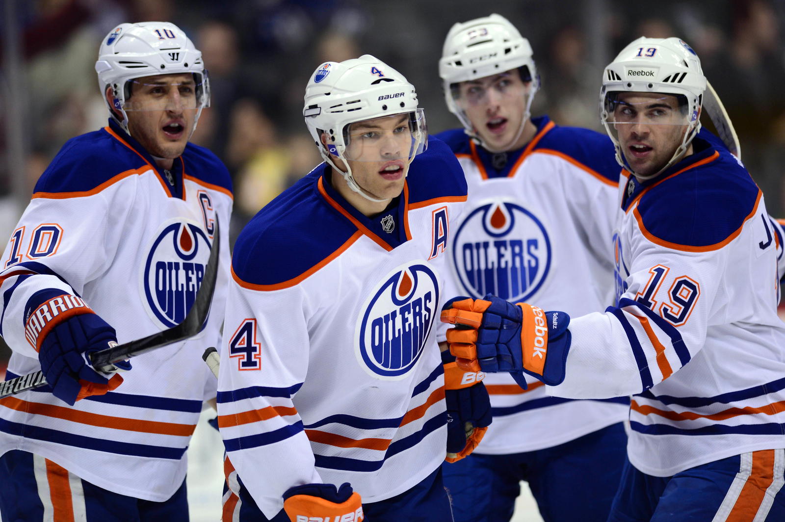 March 12 2013; Denver, CO, USA; Edmonton Oilers center Shawn Horcoff (10) and Edmonton Oilers left wing Taylor Hall (4) and Edmonton Oilers right wing Ryan Jones (28) and Edmonton Oilers center Ryan Nugent-Hopkins (93) react to the fourth goal of the game in the third period of the game against the Colorado Avalanche at the Pepsi Center. The Oilers defeated the Avalanche 4-0. (Ron Chenoy-Imagn Images)