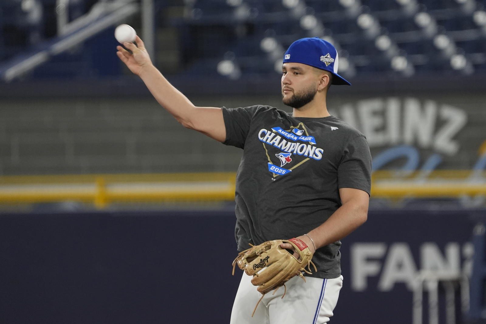 Toronto Blue Jays shortstop Bo Bichette (11) throws a ball during batting pratice on media day before game one of the World Series at Rogers Centre. John E. Sokolowski-Imagn Images