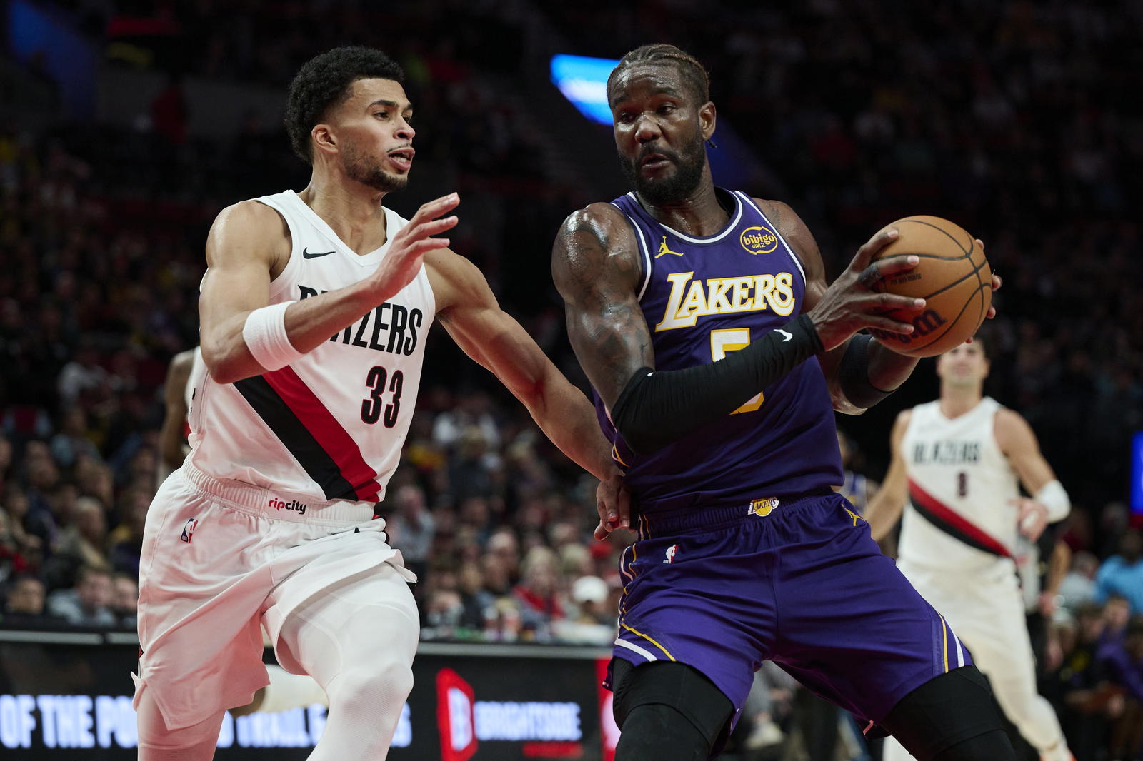 Los Angeles Lakers center Deandre Ayton (5) drives to the basket during the second half against Portland Trail Blazers forward Toumani Camara (33) at Moda Center. Troy Wayrynen-Imagn Images