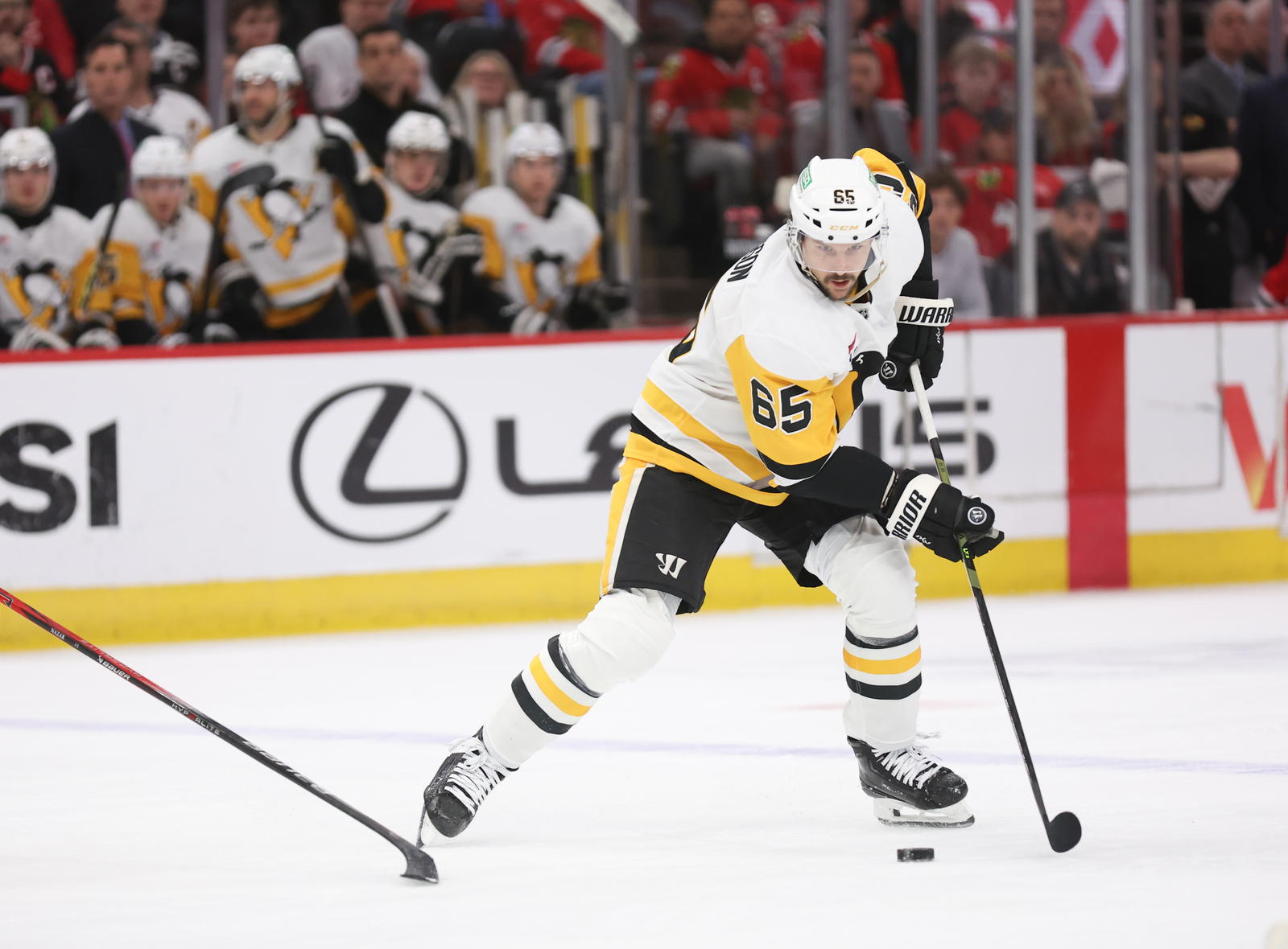 Apr 6, 2025; Chicago, Illinois, USA; Pittsburgh Penguins defenseman Erik Karlsson (65) skates with the puck against the Chicago Blackhawks during the second period at United Center. Mandatory Credit: Talia Sprague-Imagn Images