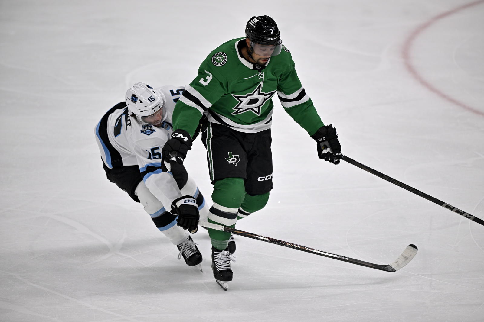 Apr 12, 2025; Dallas, Texas, USA; Dallas Stars defenseman Matt Dumba (3) keeps the puck away from Utah Hockey Club center Alexander Kerfoot (15) during the first period at the American Airlines Center. Mandatory Credit: Jerome Miron-Imagn Images