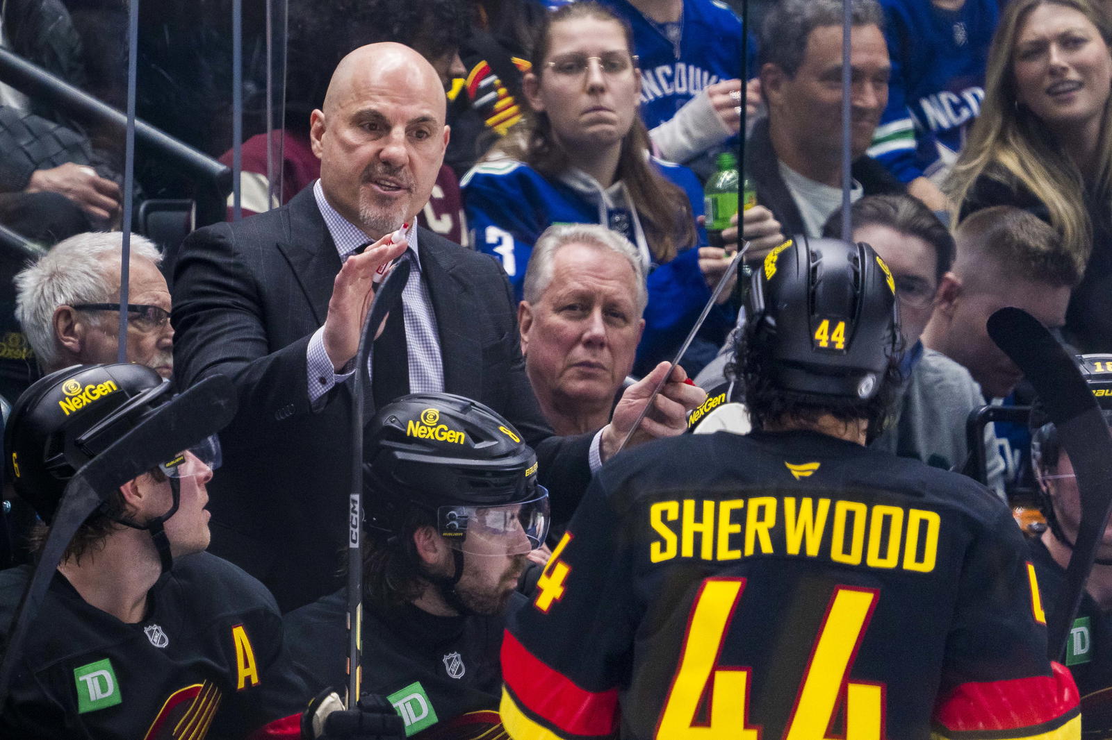 Mar 7, 2025; Vancouver, British Columbia, CAN; Vancouver Canucks head coach Rick Tocchet talks with forward Kiefer Sherwood (44) on the bench against the Minnesota Wild in the third period at Rogers Arena. Mandatory Credit: Bob Frid-Imagn Images