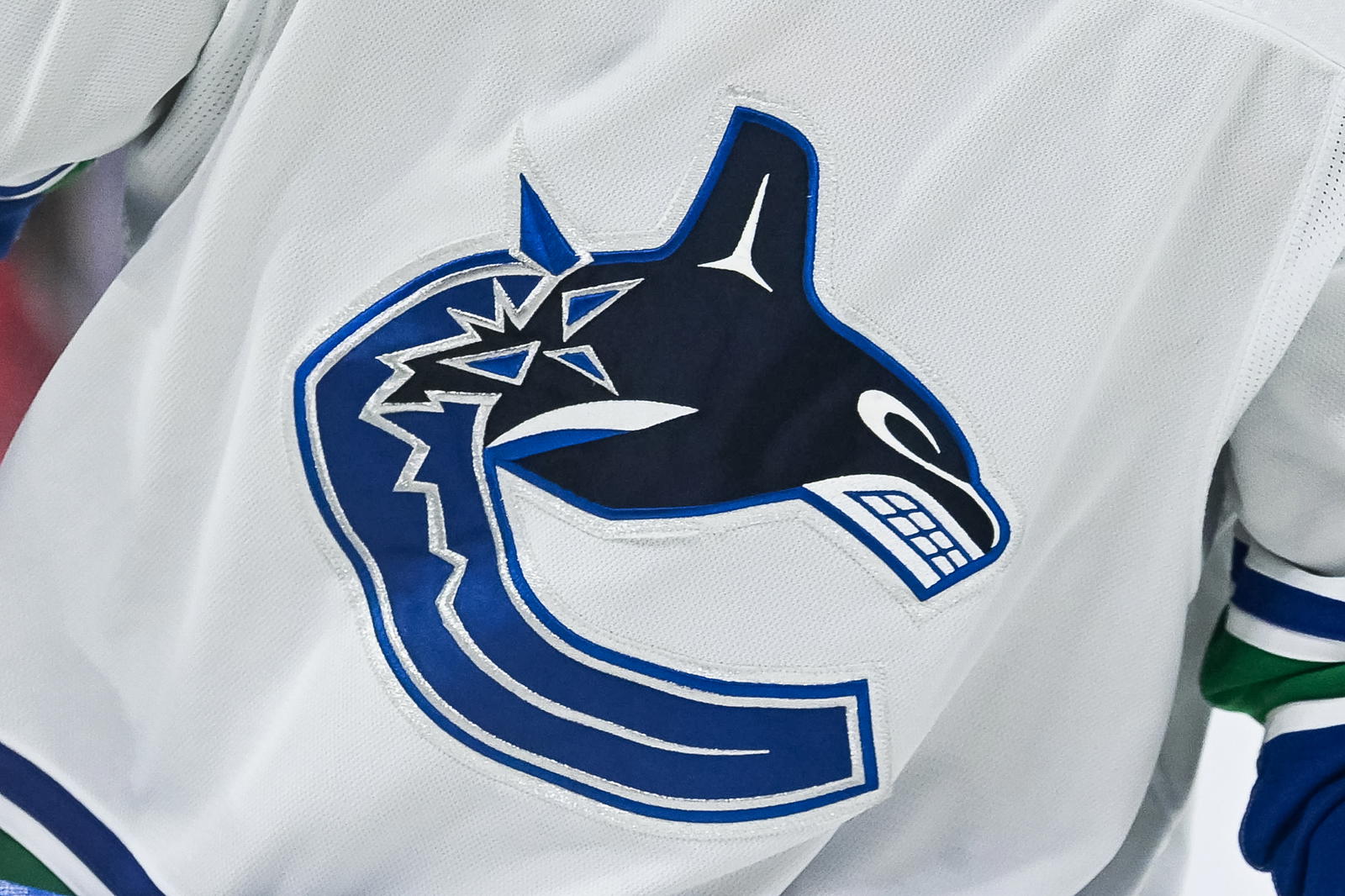 Nov 12, 2023; Montreal, Quebec, CAN; View of a Vancouver Canucks logo on a jersey worn by a member of the team against the Montreal Canadiens during the second period at Bell Centre. Mandatory Credit: David Kirouac-Imagn Images