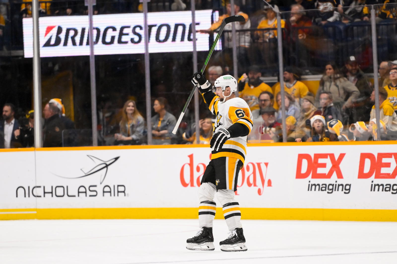 Dec 19, 2024; Nashville, Tennessee, USA; Pittsburgh Penguins defenseman Erik Karlsson (65) celebrates his goal against the Nashville Predators during the third period at Bridgestone Arena. Mandatory Credit: Steve Roberts-Imagn Images