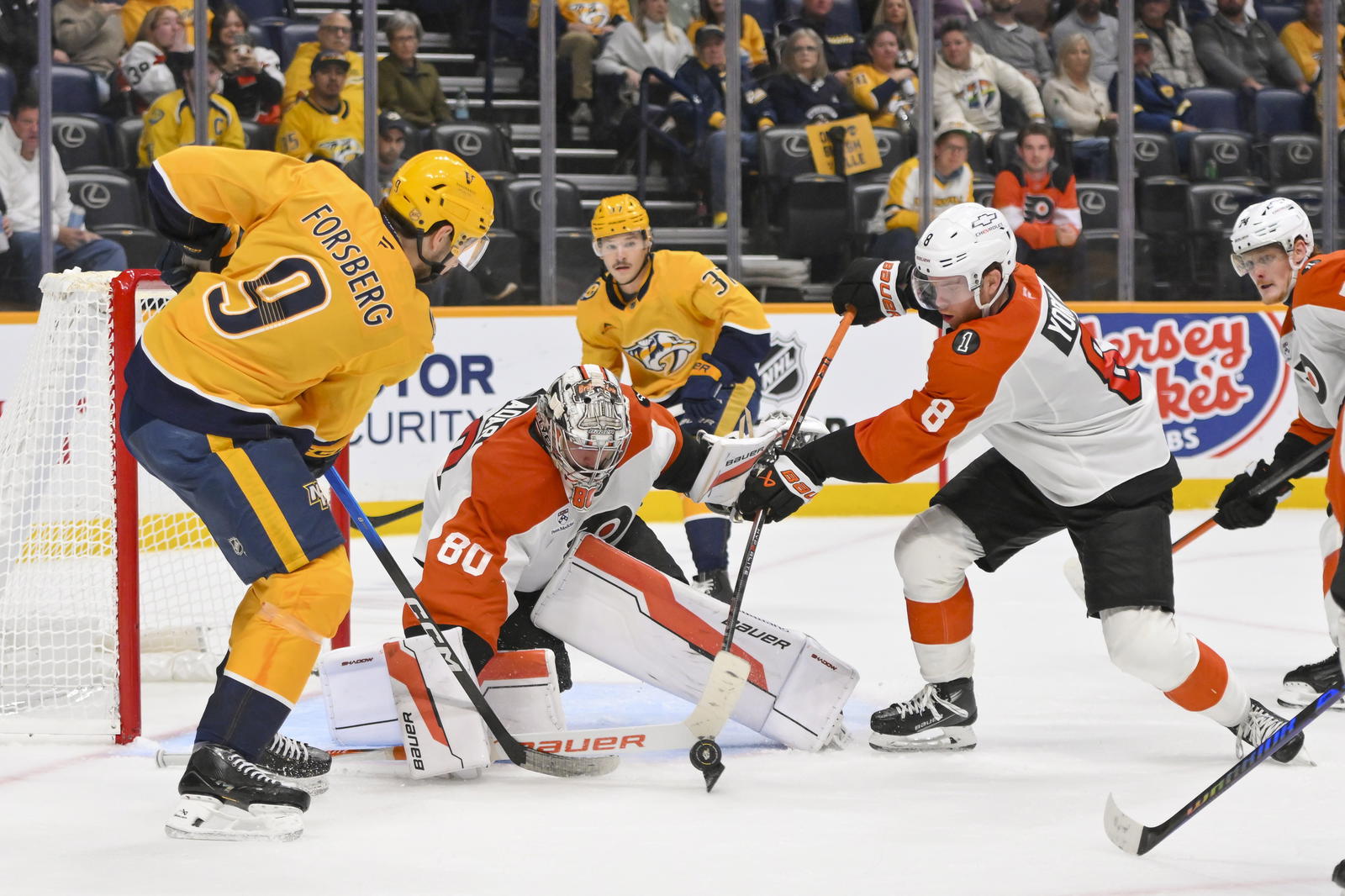 Nov 6, 2025; Nashville, Tennessee, USA; Nashville Predators left wing Filip Forsberg (9) and Philadelphia Flyers defenseman Cam York (8) battle for the puck during the third period at Bridgestone Arena. Steve Roberts-Imagn Images
