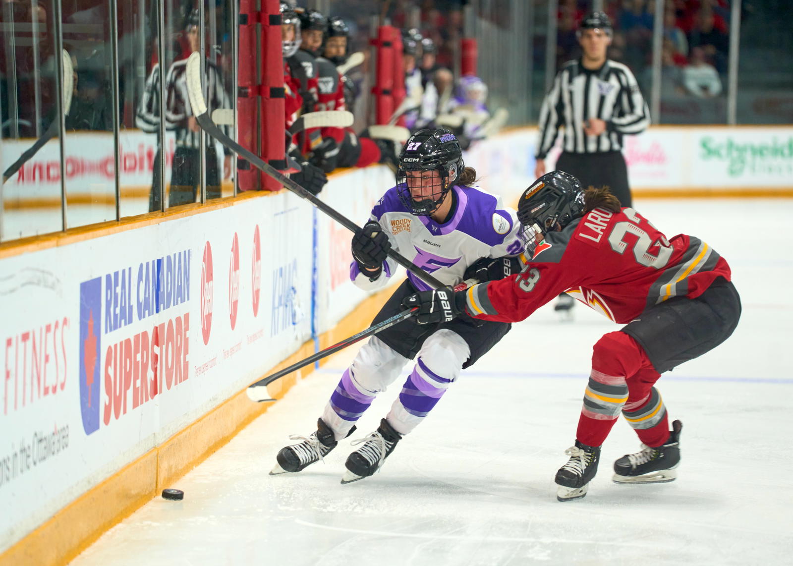 Jocelyne Larocque looks to check Taylor Heise - Photo @ Ellen Bond
