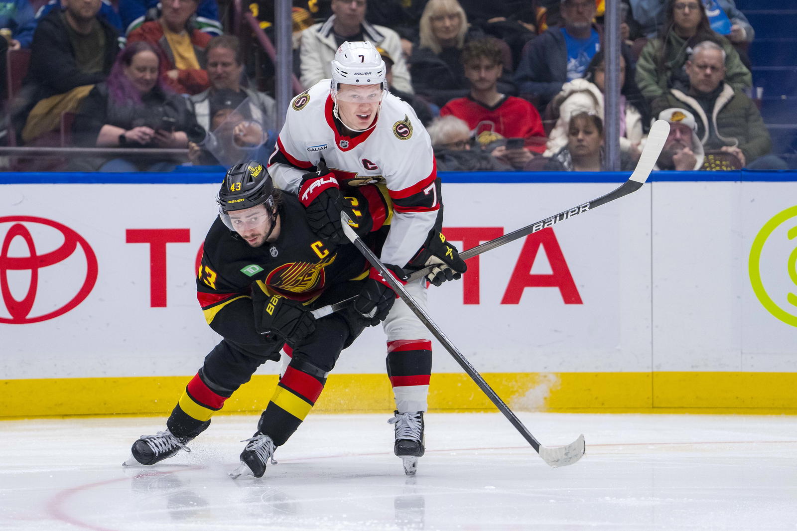 Dec 21, 2024; Vancouver, British Columbia, CAN; Ottawa Senators forward Brady Tkachuk (7) battles with Vancouver Canucks defenseman Quinn Hughes (43) during the third period at Rogers Arena. Mandatory Credit: Bob Frid-Imagn Images