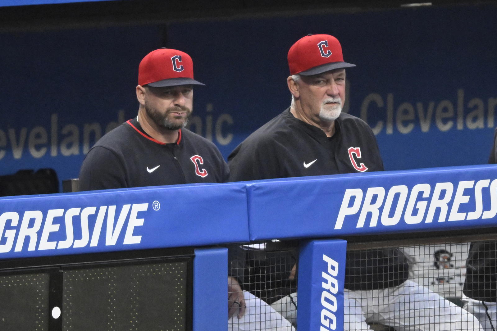 Sep 10, 2025; Cleveland, Ohio, USA; Cleveland Guardians manager Stephen Vogt (12) and pitching coach Carl Willis (51) look on from the dugout in the fourth inning against the Kansas City Royals at Progressive Field. Mandatory Credit: David Richard-Imagn Images