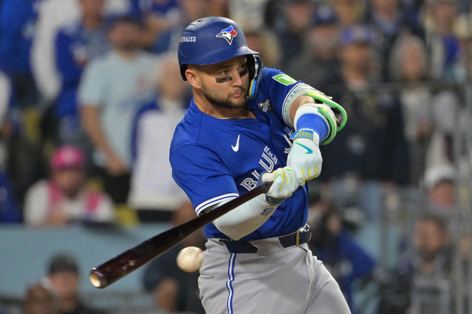 Oct 27, 2025; Los Angeles, California, USA; Toronto Blue Jays second baseman Bo Bichette (11) hits an RBI single against the Los Angeles Dodgers in the seventh inning during game three of the 2025 MLB World Series at Dodger Stadium. Mandatory Credit: Jayne Kamin-Oncea-Imagn Images