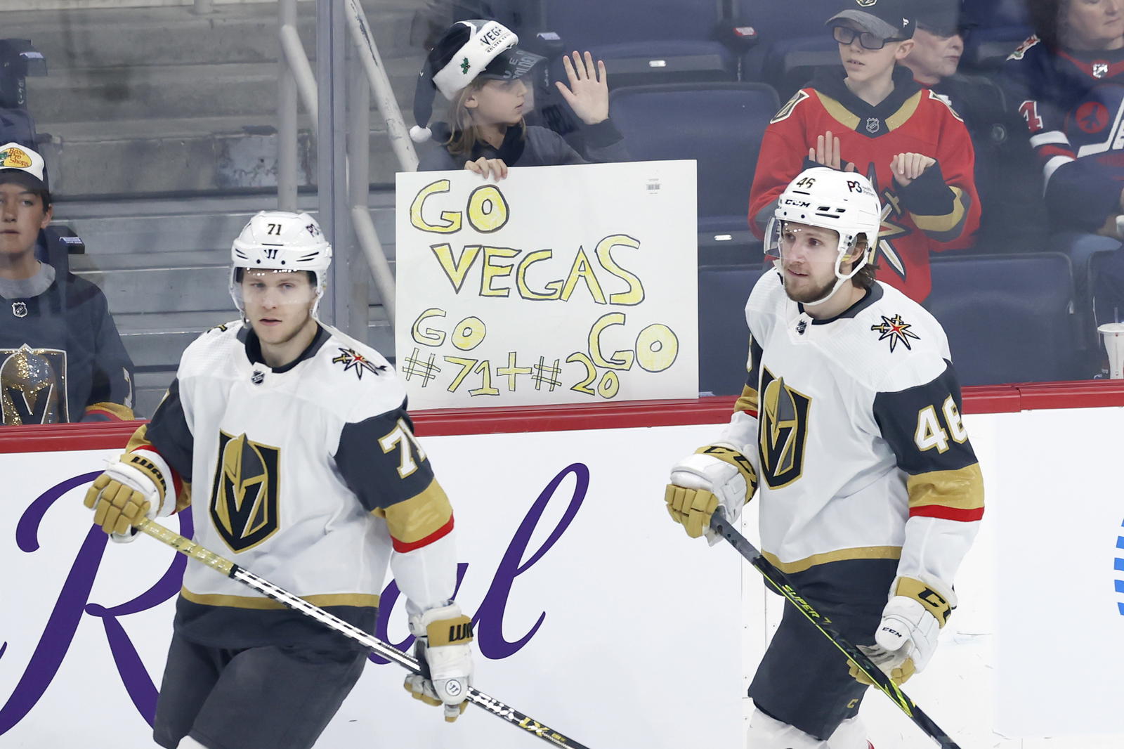 Vegas Golden Knights center William Karlsson (71) and Vegas Golden Knights Jonas Rondbjerg (46) skate past fans before a game against the Winnipeg Jets at Canada Life Centre. Mandatory Credit: James Carey Lauder-Imagn Images