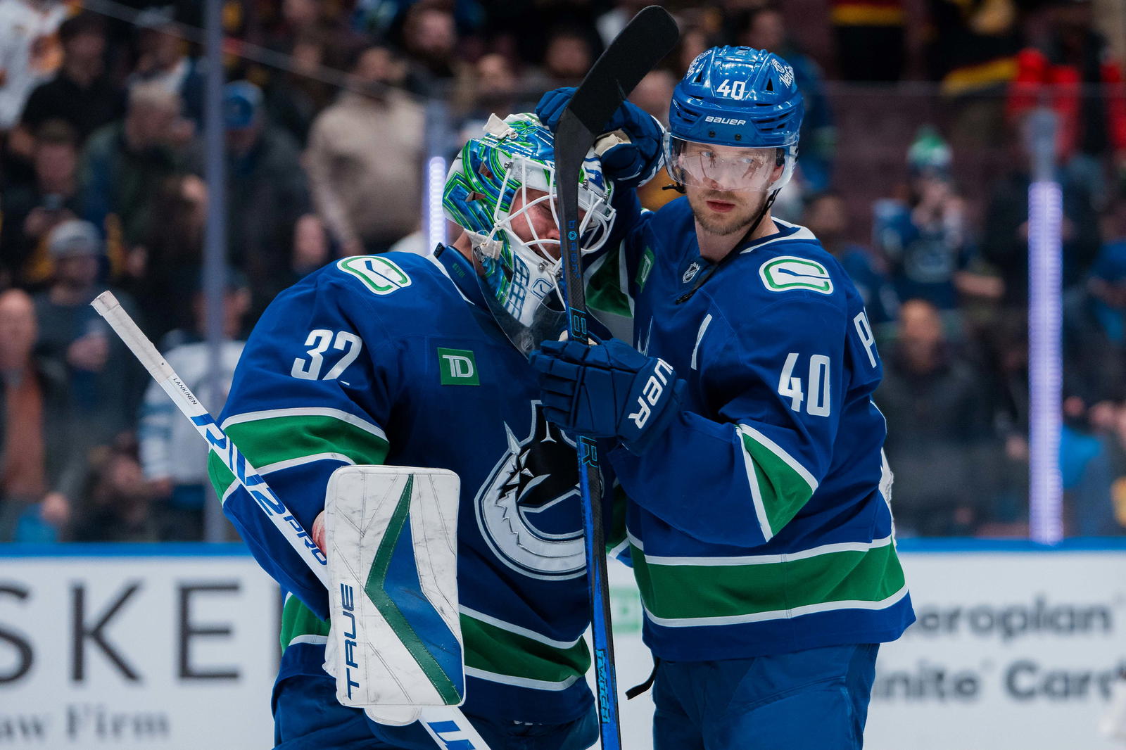 Mar 18, 2025; Vancouver, British Columbia, CAN; Vancouver Canucks goalie Kevin Lankinen (32) and forward Elias Pettersson (40) celebrate their victory against the Winnipeg Jets at Rogers Arena. Mandatory Credit: Bob Frid-Imagn Images