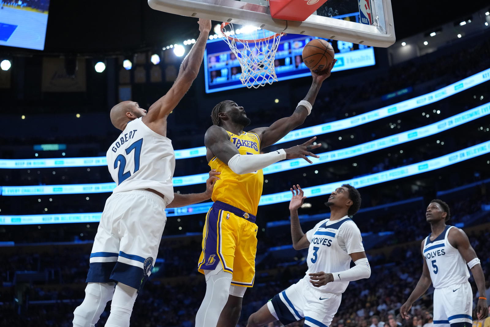 Los Angeles Lakers center Deandre Ayton (5) shoots the ball against Minnesota Timberwolves center Rudy Gobert (27), forward Jaden McDaniels (3) and guard Anthony Edwards (5) in the second half at Crypto.com Arena. Kirby Lee-Imagn Images