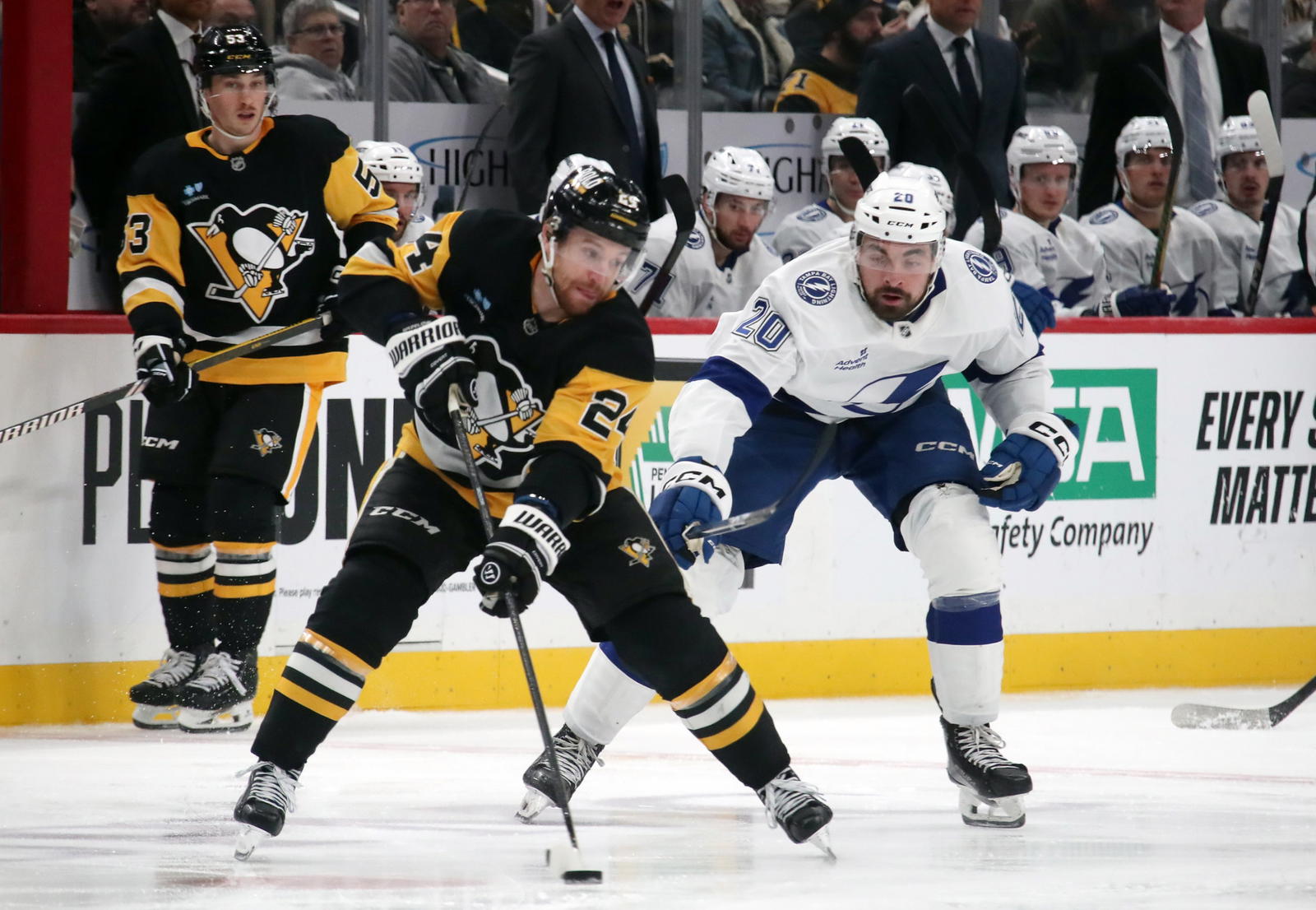 Jan 12, 2025; Pittsburgh, Pennsylvania, USA; Pittsburgh Penguins defenseman Matt Grzelcyk (24) skates with the puck against Tampa Bay Lightning left wing Nick Paul (20) during the third period at PPG Paints Arena. (Charles LeClaire-Imagn Images)