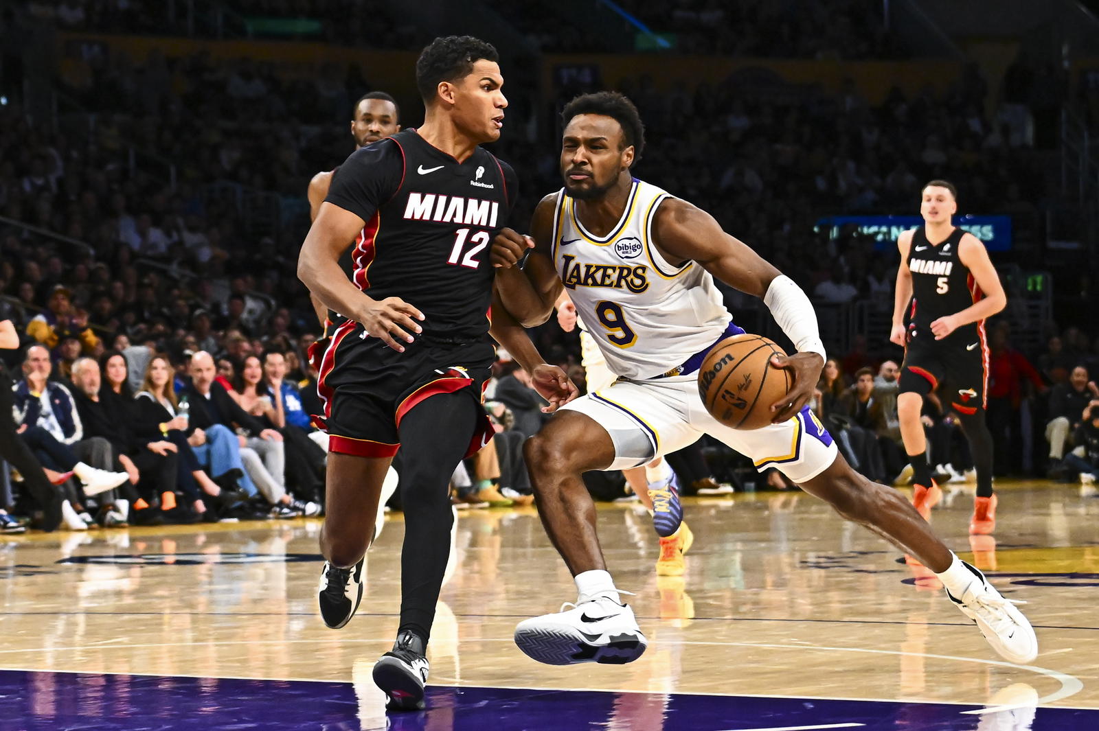 Los Angeles Lakers guard Bronny James (9) charges the net against Miami Heat guard Dru Smith (12) during the second half at Crypto.com Arena.&nbsp;Jonathan Hui-Imagn Images