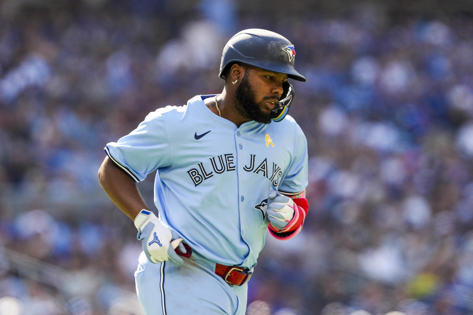  Toronto Blue Jays first base Vladimir Guerrero Jr. (27) takes a walk to first base during the seventh inning against the Baltimore Orioles at Rogers Centre. Kevin Sousa-Imagn Images