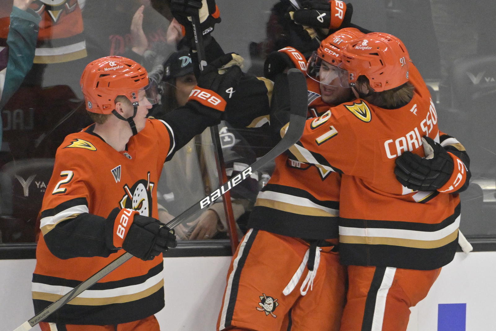 Apr 9, 2025; Anaheim, California, USA; Anaheim Ducks left wing Cutter Gauthier (61) is congratulated by defenseman Jackson LaCombe (2) and center Trevor Zegras (11) after a goal during the third period against the Calgary Flames as Honda Center. Mandatory Credit: Jayne Kamin-Oncea-Imagn Images