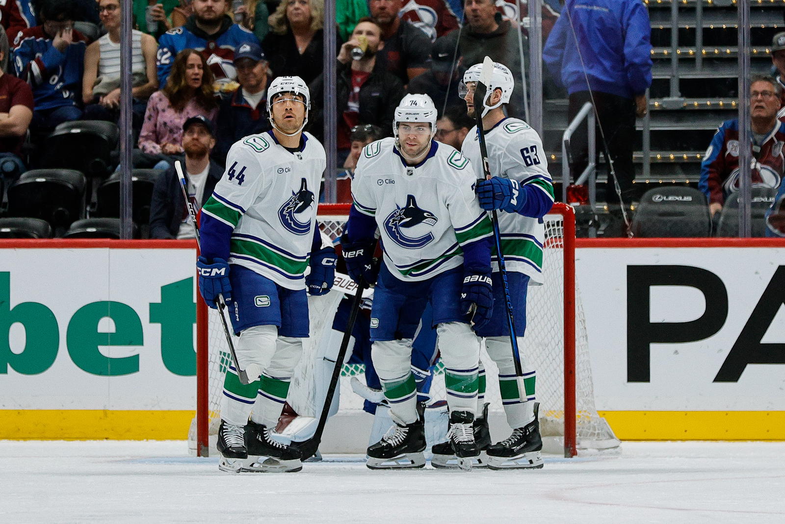 Apr 10, 2025; Denver, Colorado, USA; Vancouver Canucks left wing Jake DeBrusk (74) with left wing Kiefer Sherwood (44) and center Max Sasson (63) after scoring a goal in the second period against the Colorado Avalanche at Ball Arena. Mandatory Credit: Isaiah J. Downing-Imagn Images