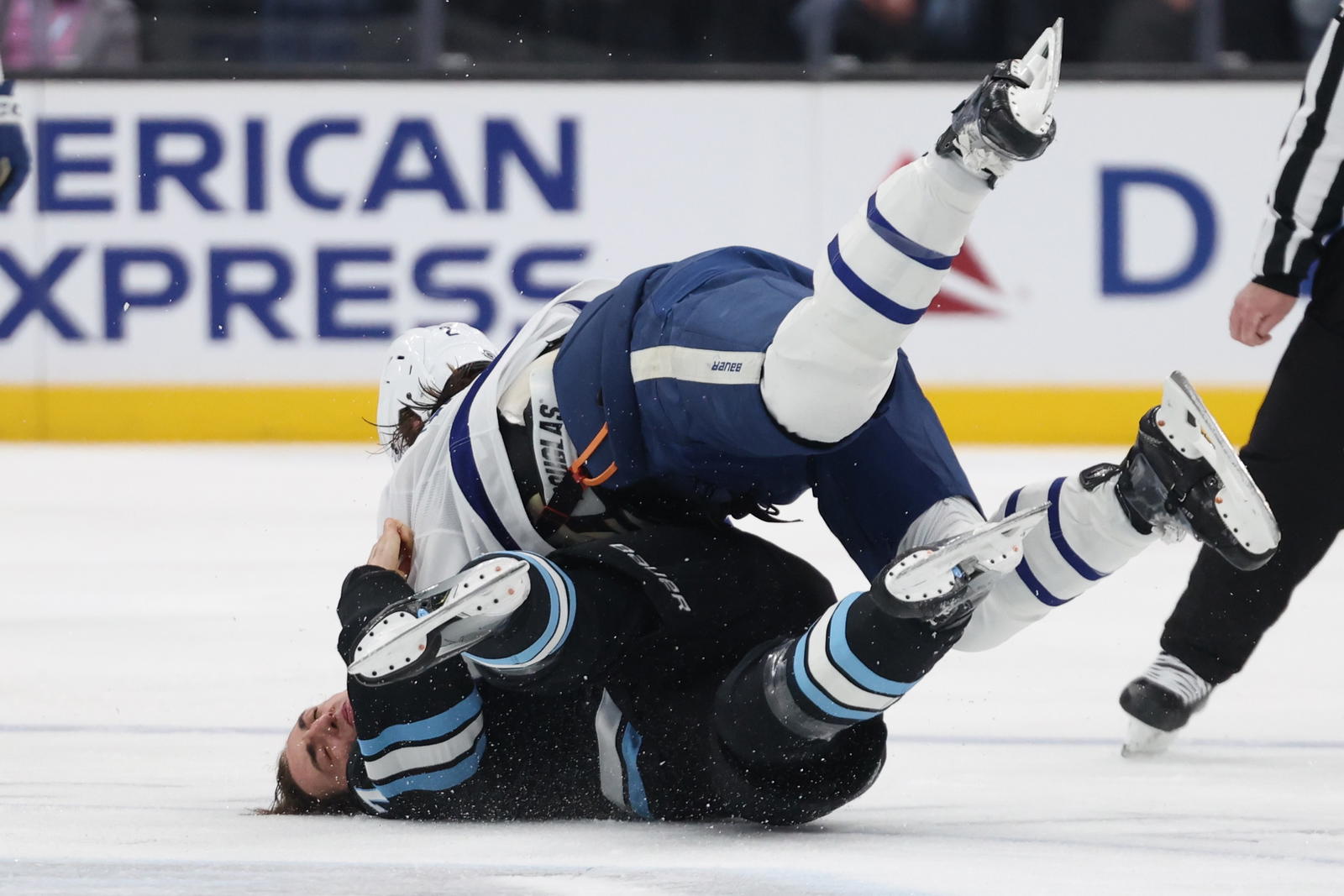 Utah Hockey Club defenseman Michael Kesselring (7) and Toronto Maple Leafs defenseman Simon Benoit (2) fight during the second period at Delta Center.
