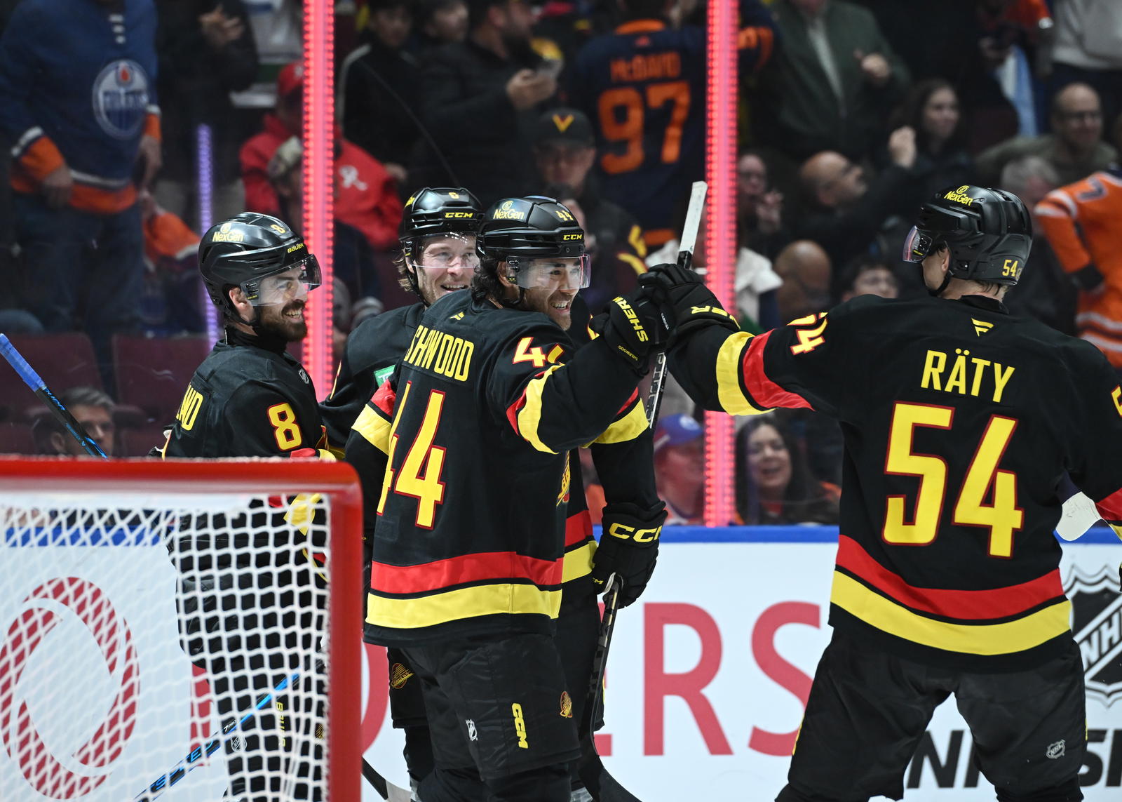 Oct 26, 2025; Vancouver, British Columbia, CAN; Vancouver Canucks left wing Kiefer Sherwood (44) celebrates the overtime win with teammates against the Edmonton Oilers at Rogers Arena. Mandatory Credit: Simon Fearn-Imagn Images