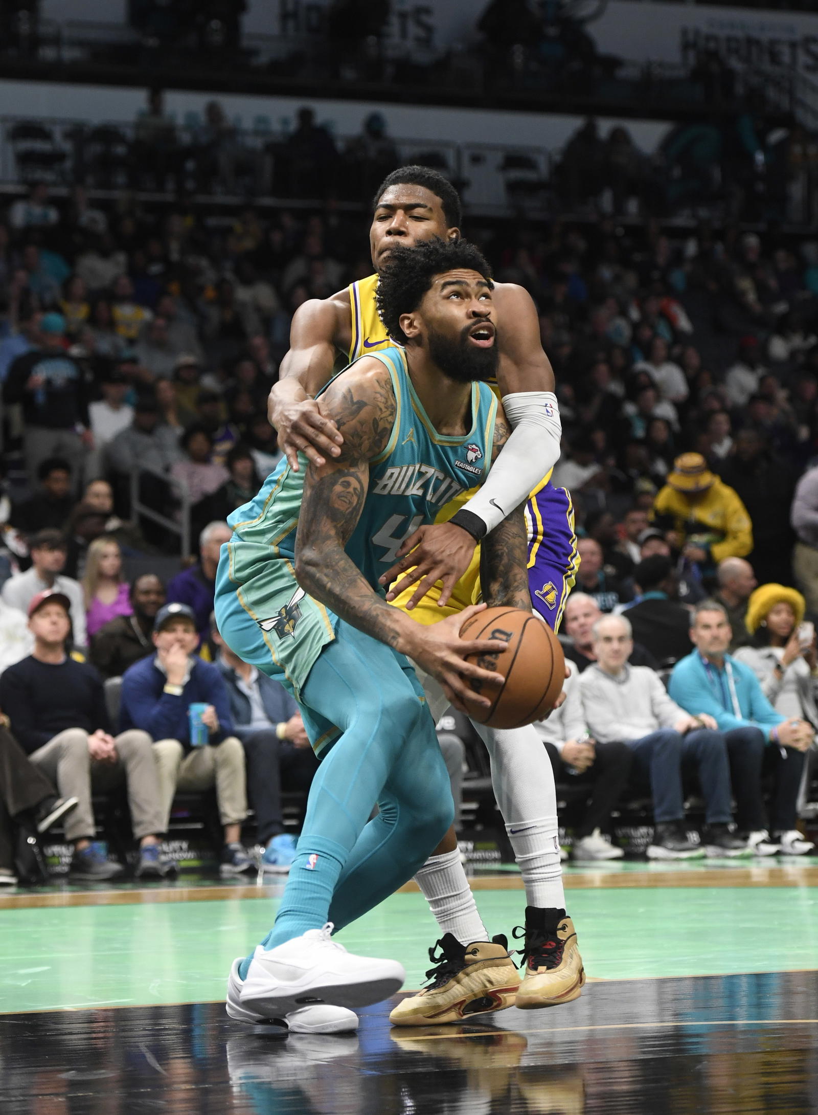 Charlotte Hornets center Nick Richards (4) gets fouled by Los Angels Lakers forward Rui Hachimura (28) during the second half at the Spectrum Center. Sam Sharpe-Imagn Images