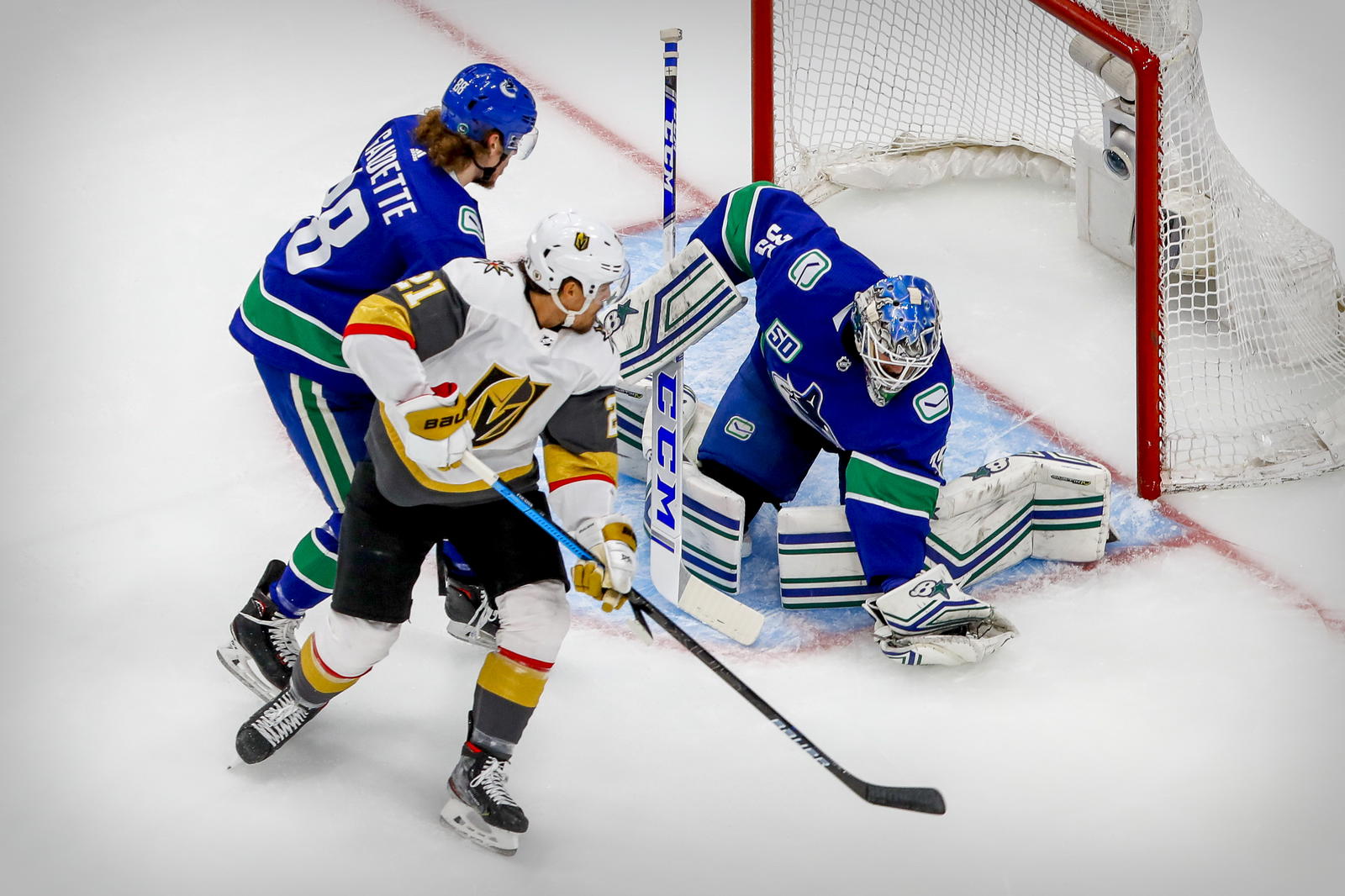 Sep 3, 2020; Edmonton, Alberta, CAN; Vancouver Canucks goaltender Thatcher Demko (35) and center Adam Gaudette (88) defend against Vegas Golden Knights center Nick Cousins (21) during the first period in game six of the second round of the 2020 Stanley Cup Playoffs at Rogers Place. Mandatory Credit: Perry Nelson-Imagn Images