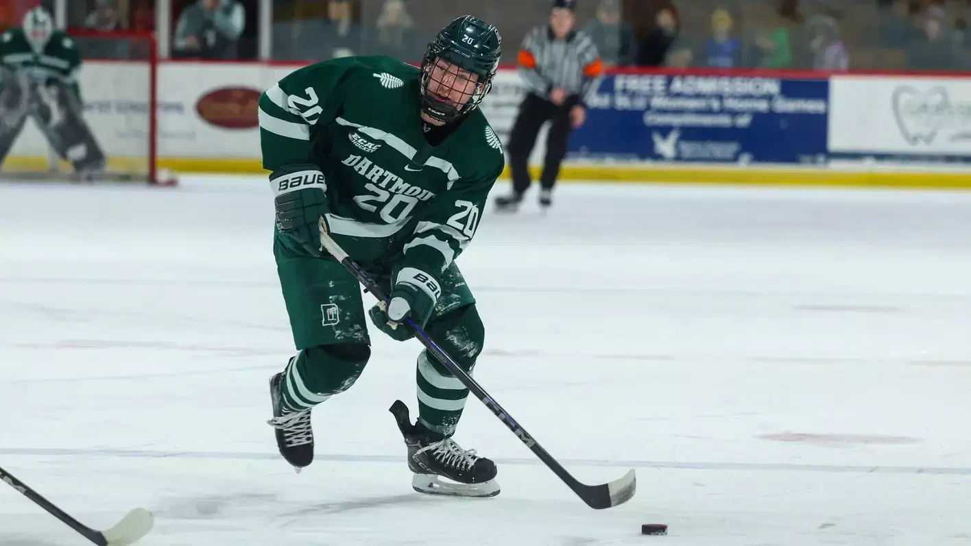 #20 Cooper Flinton of the Dartmouth Big Green skates with the puck in a game last season. via syracusecrunch.com