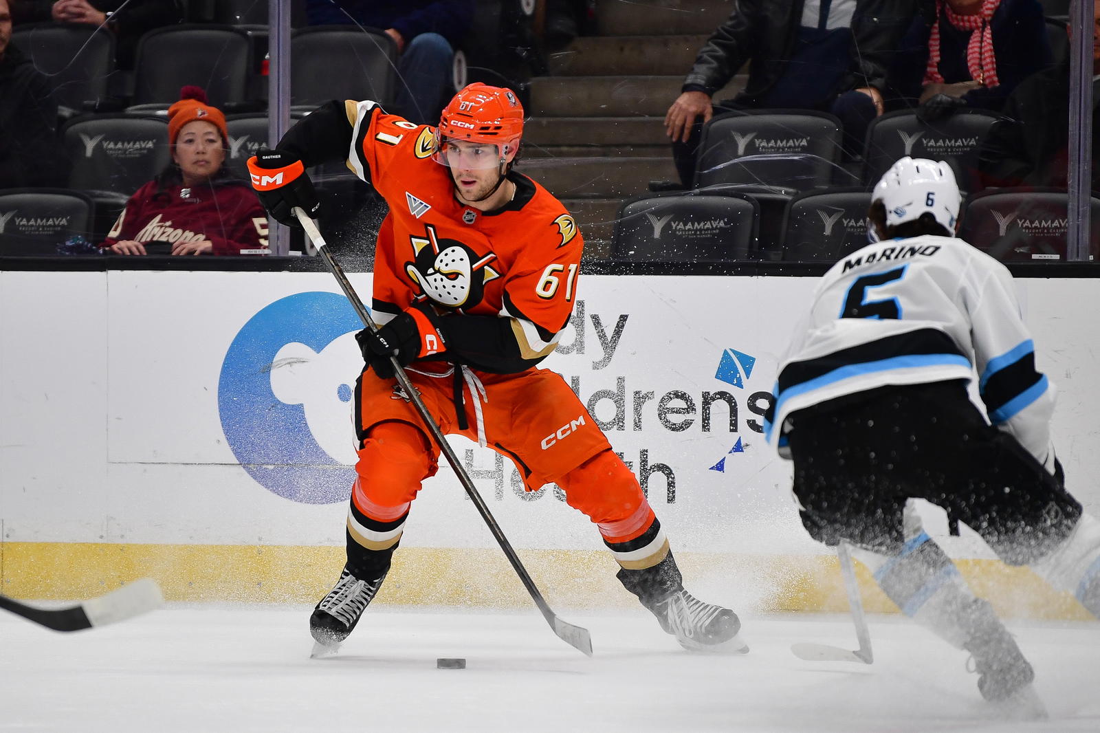 Dec 3, 2025; Anaheim, California, USA; Anaheim Ducks left wing Cutter Gauthier (61) moves the puck against Utah Mammoth defenseman John Marino (6) during the third period at Honda Center. Mandatory Credit: Gary A. Vasquez-Imagn Images