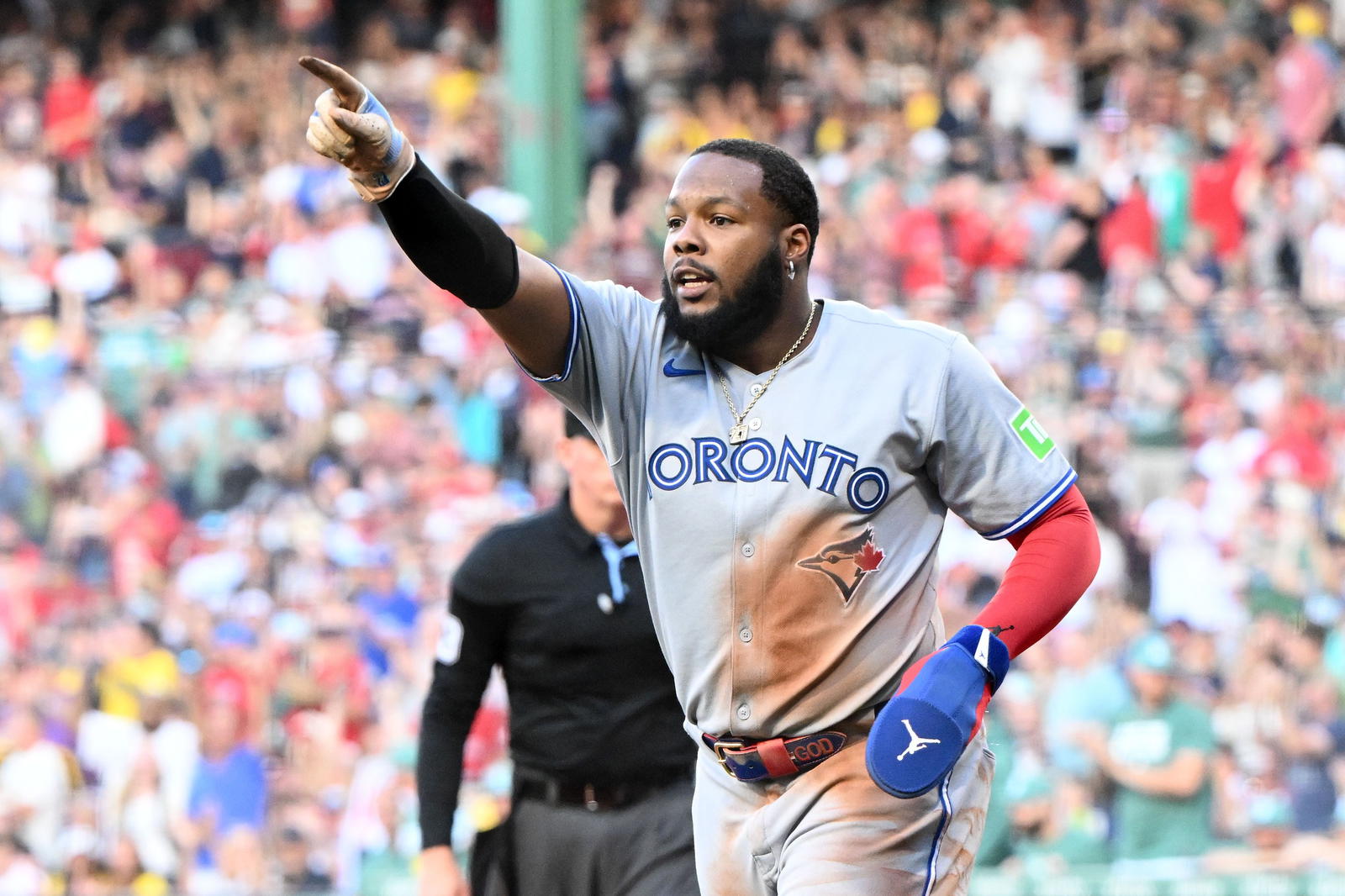 Jun 27, 2025; Boston, Massachusetts, USA; Toronto Blue Jays first baseman Vladimir Guerrero Jr. (27) reacts after being called out at home during the first inning against the Boston Red Sox at Fenway Park. The call was overturned to safe scoring a run for the Toronto Blue Jays after review. (Brian Fluharty/Imagn Images)