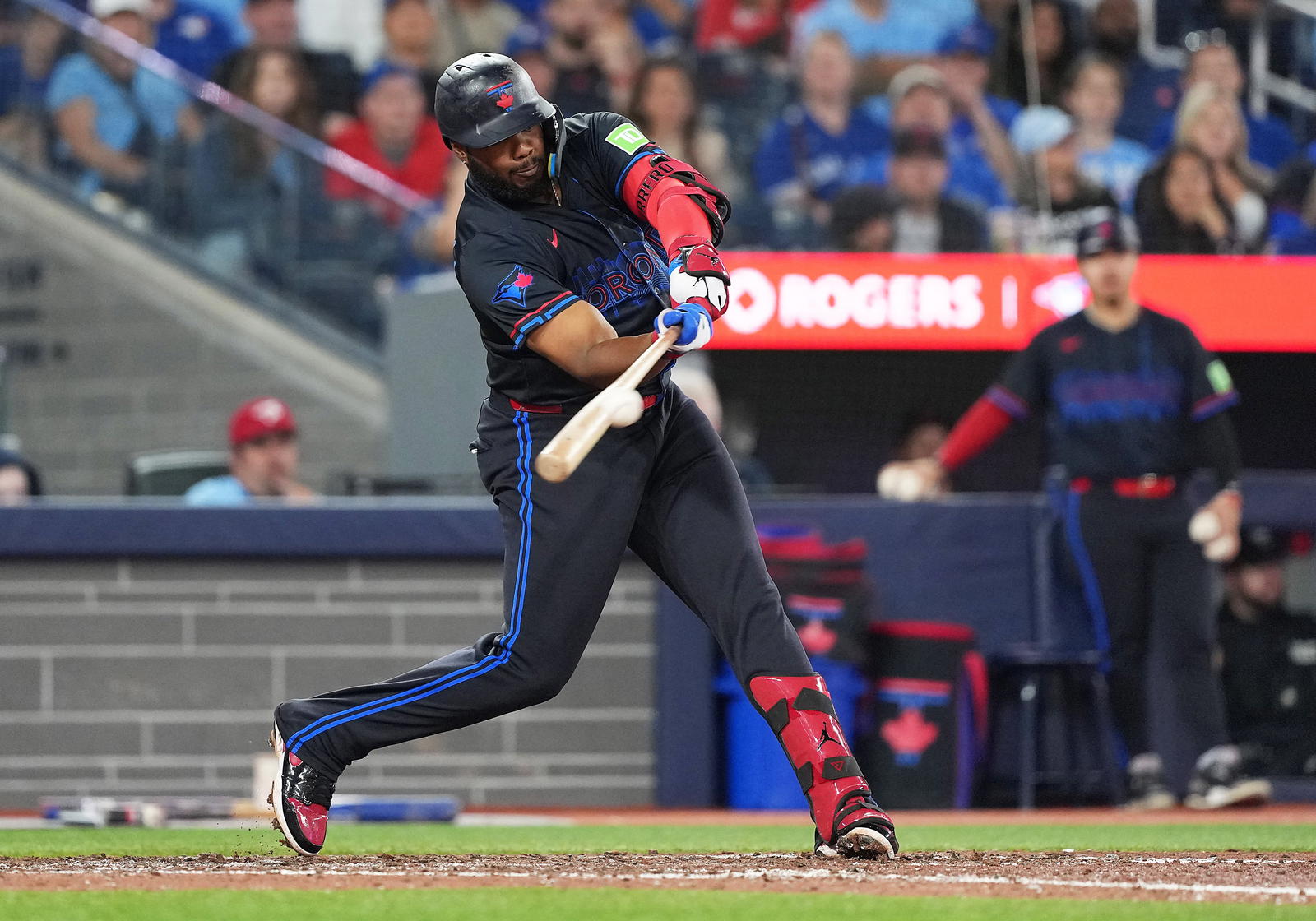 Toronto Blue Jays designated hitter Vladimir Guerrero Jr. (27) hits an RBI single but gets out at second base against the Baltimore Orioles during the eighth inning at Rogers Centre. Nick Turchiaro-Imagn Images