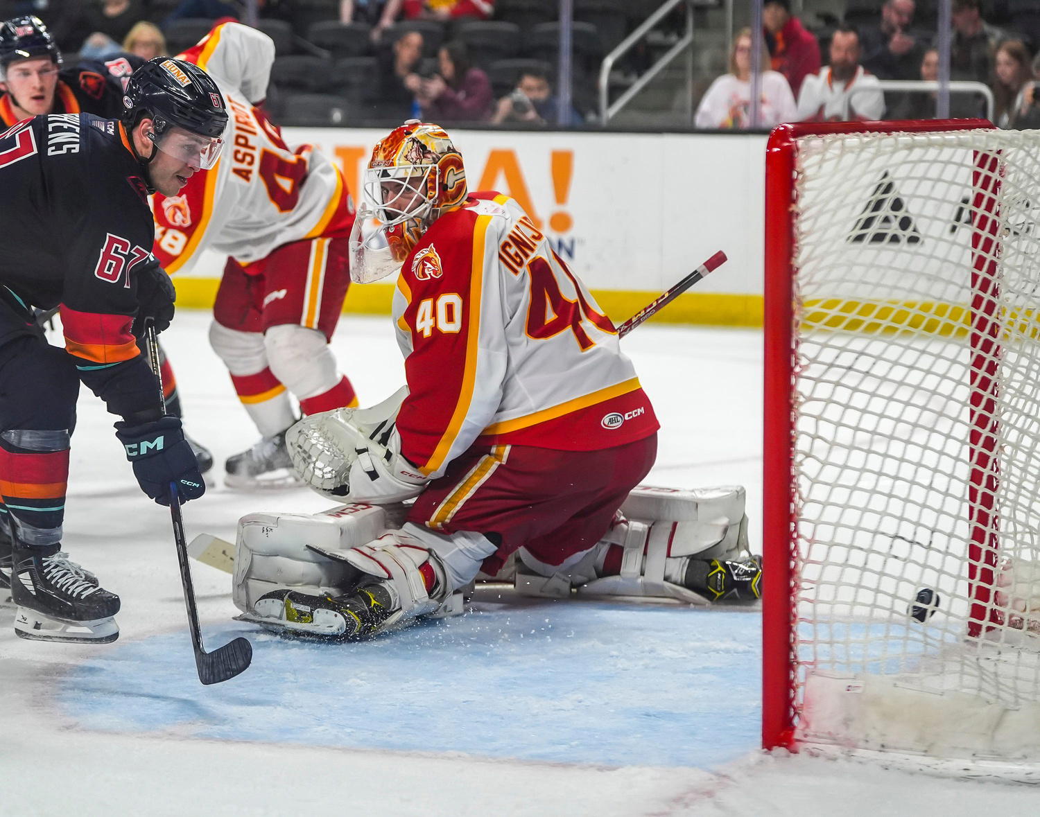 Coachella Valley forward Mitchell Stephens slips a shot by Calgary goalie Waltteri Ignatjew during the second period of Game 1 of their first-round playoff series at Acrisure Arena in Palm Desert, Calif., Tuesday, April 22, 2025.