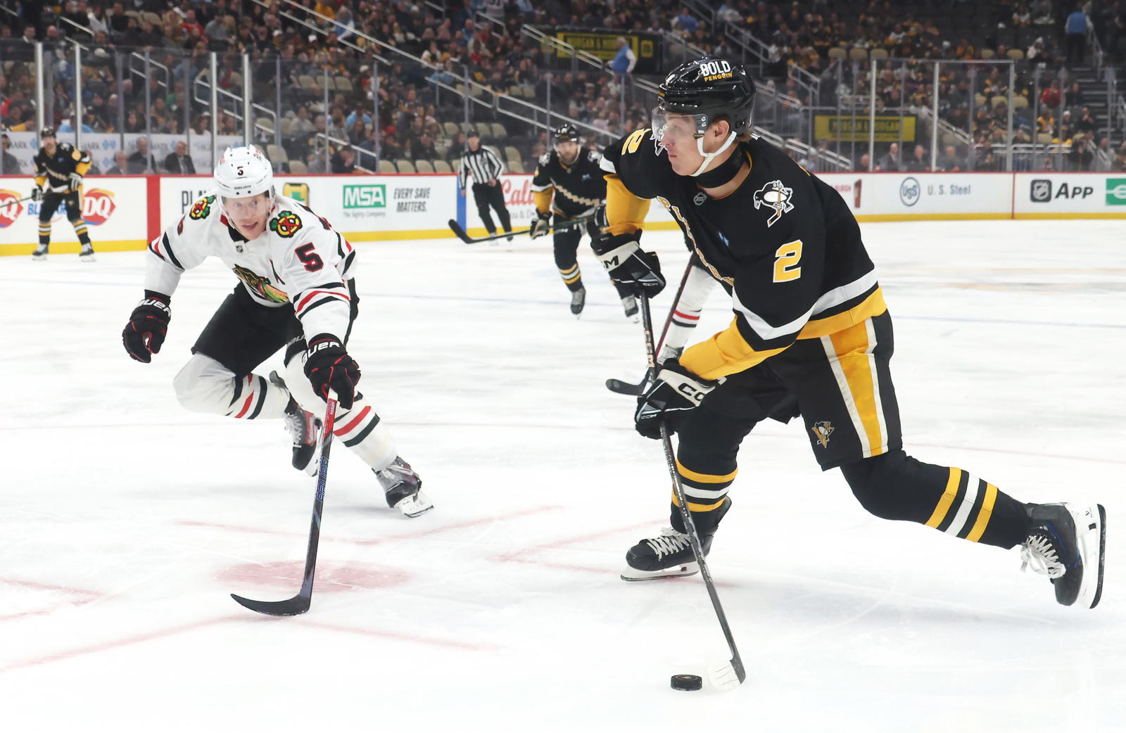 Apr 8, 2025; Pittsburgh, Pennsylvania, USA; Pittsburgh Penguins right wing Rutger McGroarty (2) shoots the puck as Chicago Blackhawks defenseman Connor Murphy (5) defends during the first period at PPG Paints Arena. Mandatory Credit: Charles LeClaire-Imagn Images