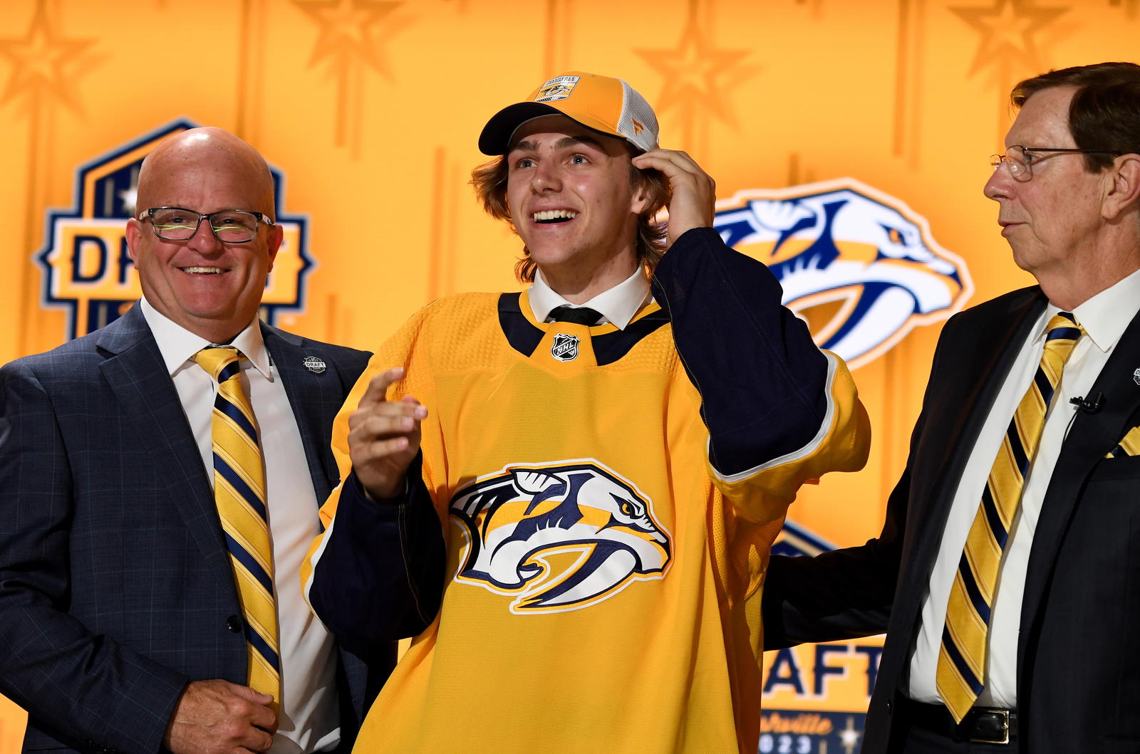 Nashville Predators draft pick Tanner Molendyk puts on a hat after being selected with the twenty-fourth pick in round one of the 2023 NHL Draft at Bridgestone Arena. Christopher Hanewinckel-Imagn Images