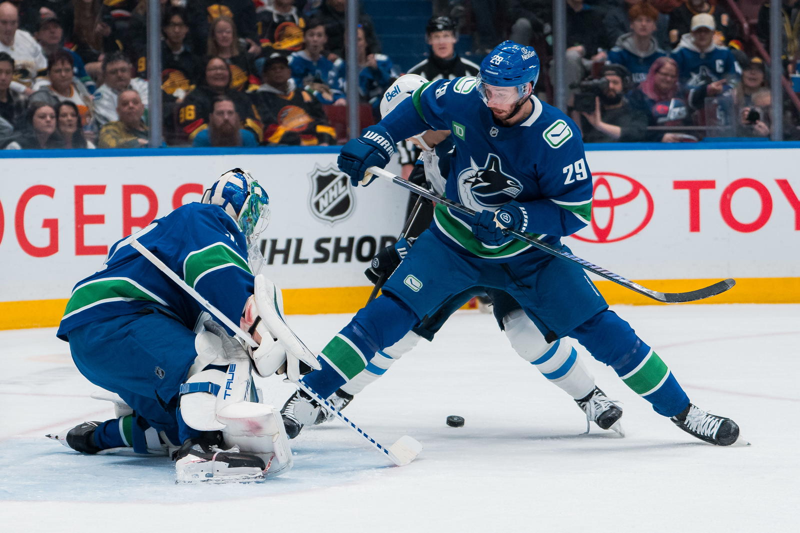 Mar 18, 2025; Vancouver, British Columbia, CAN; Vancouver Canucks goalie Kevin Lankinen (32) watches as Winnipeg Jets forward Vladislav Namestnikov (7) battles with defenseman Marcus Pettersson (29) in the first period at Rogers Arena. Mandatory Credit: Bob Frid-Imagn Images
