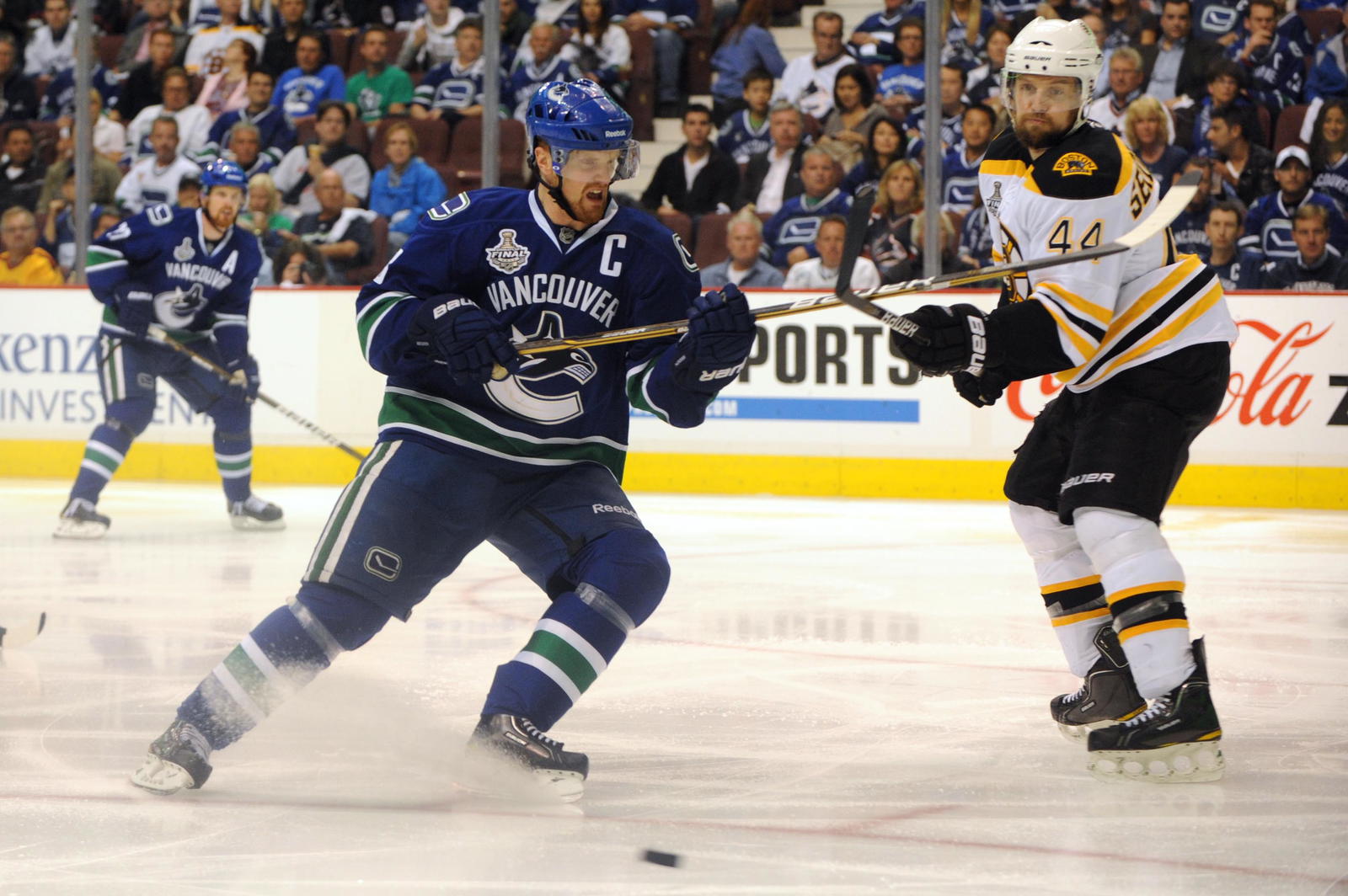 Henrik Sedin battles for the puck with Dennis Seidenberg in the third period of Game 7 of the 2011 Stanley Cup final. (Anne-Marie Sorvin-Imagn Images)