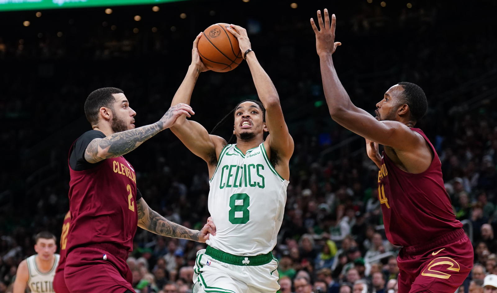 Oct 29, 2025; Boston, Massachusetts, USA; Boston Celtics forward Josh Minott (8) drives the ball against Cleveland Cavaliers center Evan Mobley (4) and guard Lonzo Ball (2) in the second quarter at TD Garden. (David Butler II/Imagn Images)